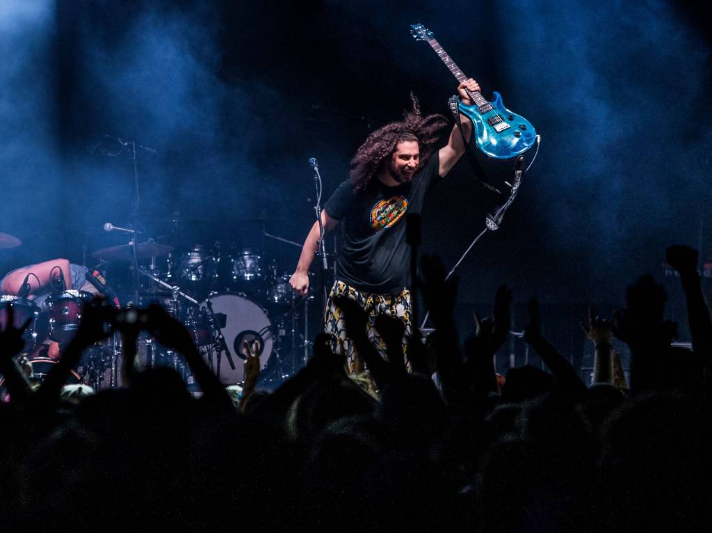 Pigeons Playing Ping Pong vocalist and guitarist raises his instrument in the air after their performance during the first day of Summer Meltdown on Thursday, Aug. 1, 2019 in Darrington, Wash. (Olivia Vanni / The Herald)