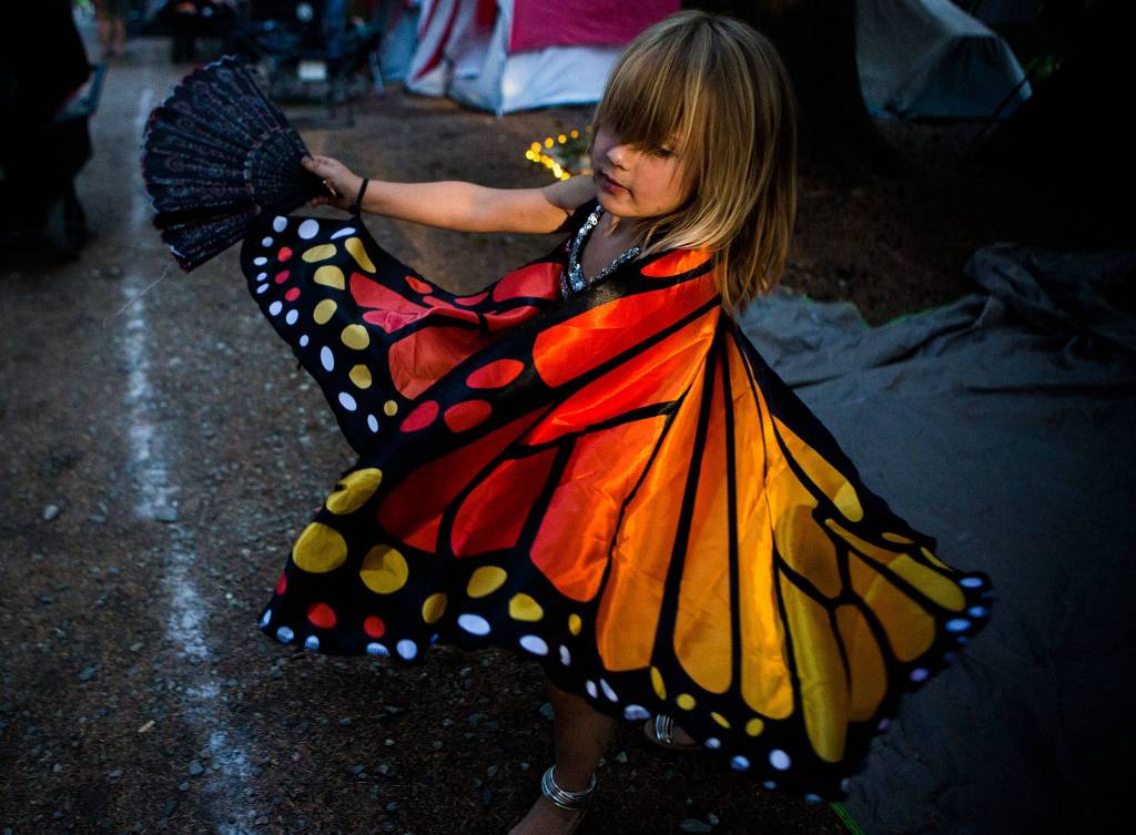 Chloe Cronin, 5, dances in a butterfly costume in the campgrounds during the first day of Summer Meltdown on Thursday, Aug. 1, 2019 in Darrington, Wash. (Olivia Vanni / The Herald)