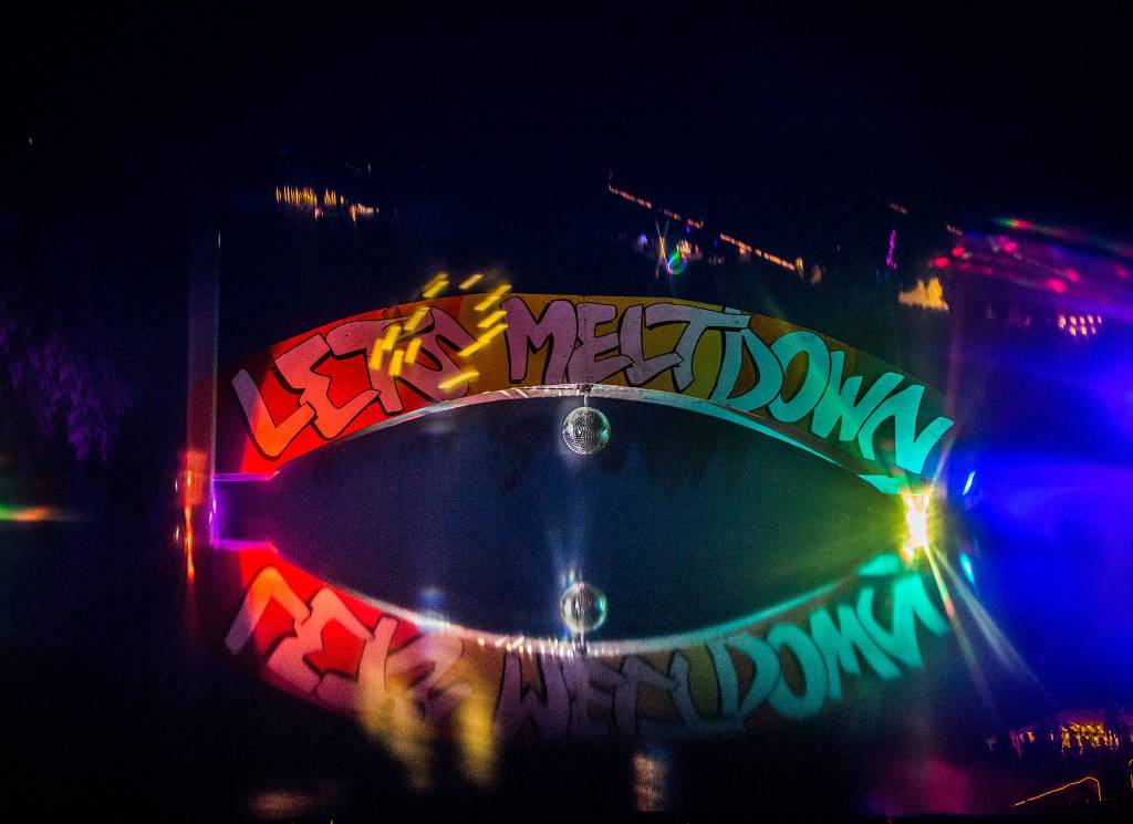 A Summer Meltdown sign is lit up during the first day of Summer Meltdown on Thursday, Aug. 1, 2019 in Darrington, Wash. (Olivia Vanni / The Herald)