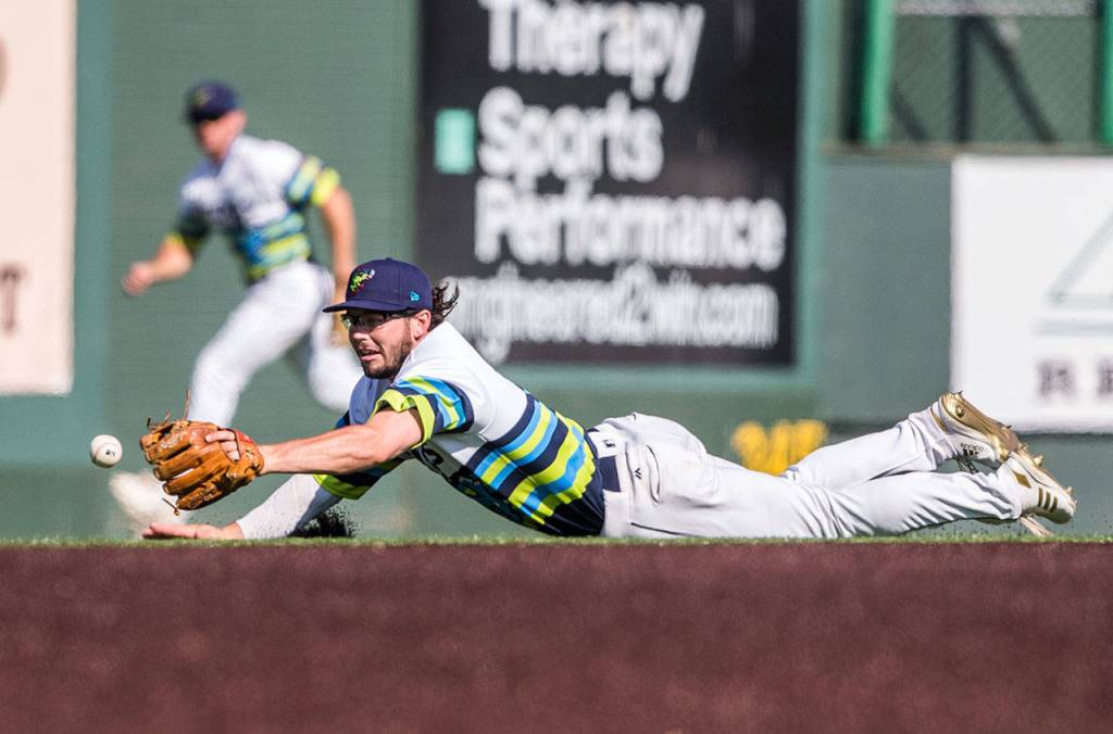 Everetts Connor Hoover dives for a ground ball during the AquaSox 7-6, 10-inning victory over Spokane on Sunday at Funko Field in Everett. (Olivia Vanni / The Herald)