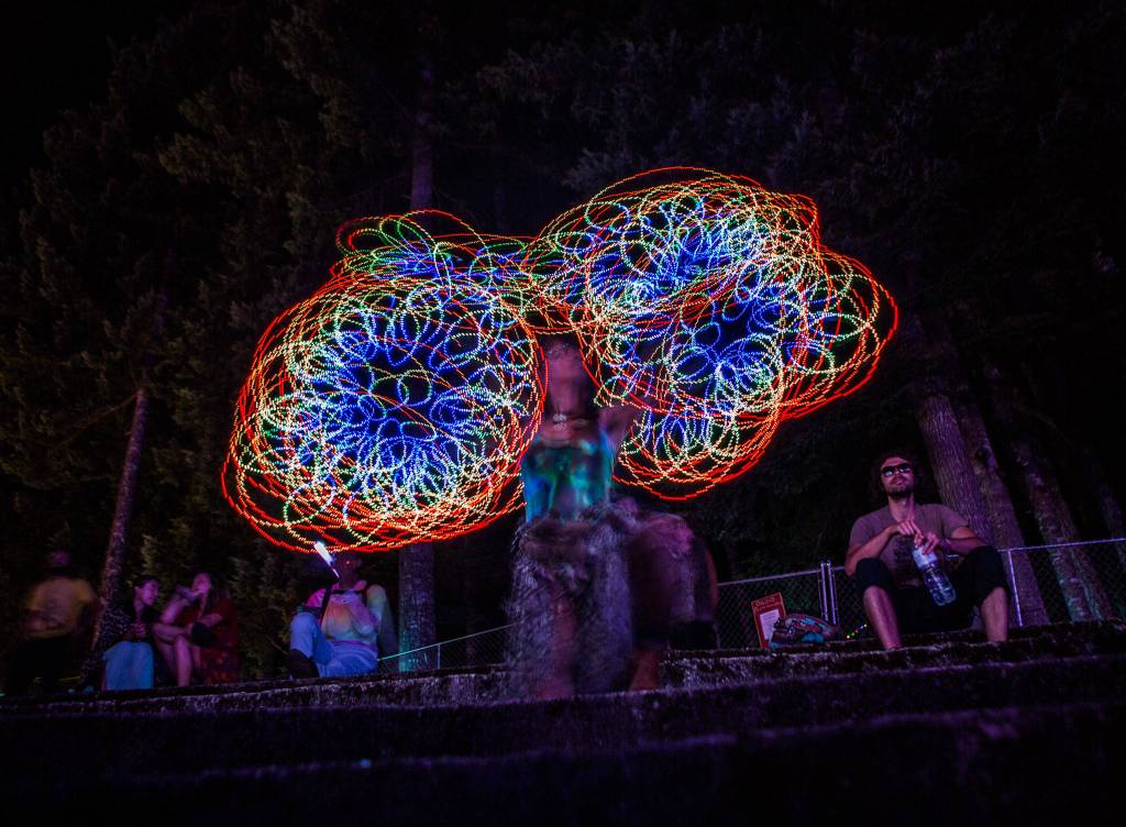 Leila Magnolia plays with her light up flow toys during the second day of Summer Meltdown on Friday, Aug. 2, 2019 in Darrington, Wash. (Olivia Vanni / The Herald)