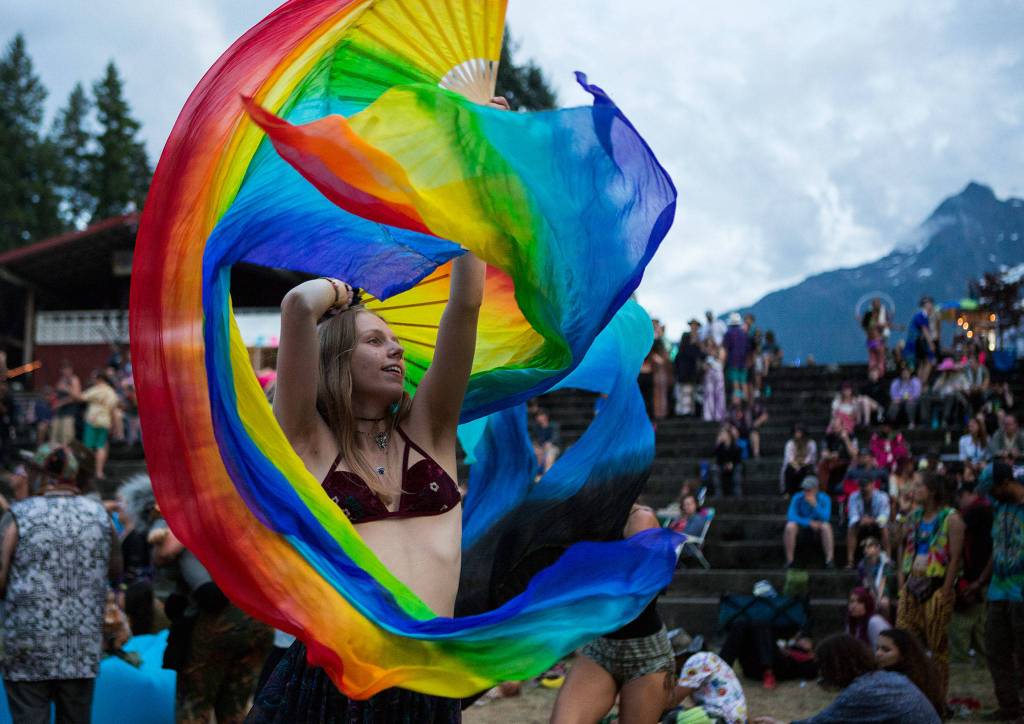 Mya Hossack dances with rainbow fans during Umphreys McGee during the second day of Summer Meltdown on Friday, Aug. 2, 2019 in Darrington, Wash. (Olivia Vanni / The Herald)