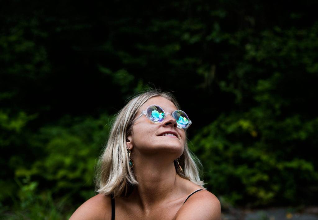 Miranda McPadden looks up at the sky at sunset along the river during the second day of Summer Meltdown on Friday, Aug. 2, 2019 in Darrington, Wash. (Olivia Vanni / The Herald)