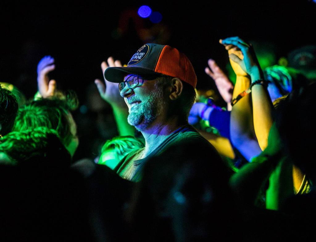 A festival goer smiles during Umphreys McGee during the second day of Summer Meltdown on Friday, Aug. 2, 2019 in Darrington, Wash. (Olivia Vanni / The Herald)