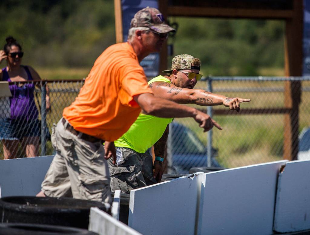 Parents and spectators yell and signal to the racers during the Washington Quarter Midgets Associations Wild Wild West race on Aug. 4 in Monroe. (Olivia Vanni / The Herald)