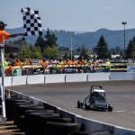 A checkered flag signals the end of a race at the Washington Quarter Midgets Associations Wild Wild West race on Aug. 4 in Monroe. (Olivia Vanni / The Herald)