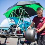 Lily Jo Decker, 8, checks the tires on her car before her race at the Washington Quarter Midgets Associations Wild Wild West race on Aug. 4 in Monroe. (Olivia Vanni / The Herald)