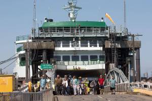Walk-on passengers disembark from the ferry Suquamish at the Mukilteo ferry dock on Tuesday, Aug. 6, 2019 in Mukilteo, Wa. The Washington State Transportation Commissioners on Tuesday approved all of the proposed ferry rate increases for passengers and cars. (Andy Bronson / The Herald )