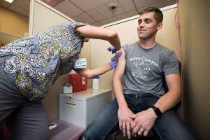 Rocky Oliphant gets a flu shot at the Everett Clinic on Tuesday, Oct. 2, 2018 in Everett, Wa. (Andy Bronson / The Herald)