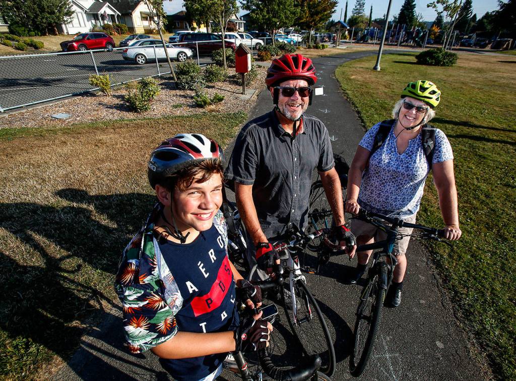 On bikes at Garfield Park, Molly Deardorff (right), John Stejer and Johns grandson, Elijah Dwyer, 13, came from Everetts Delta Neighborhood to Tuesdays event. (Dan Bates / The Herald)