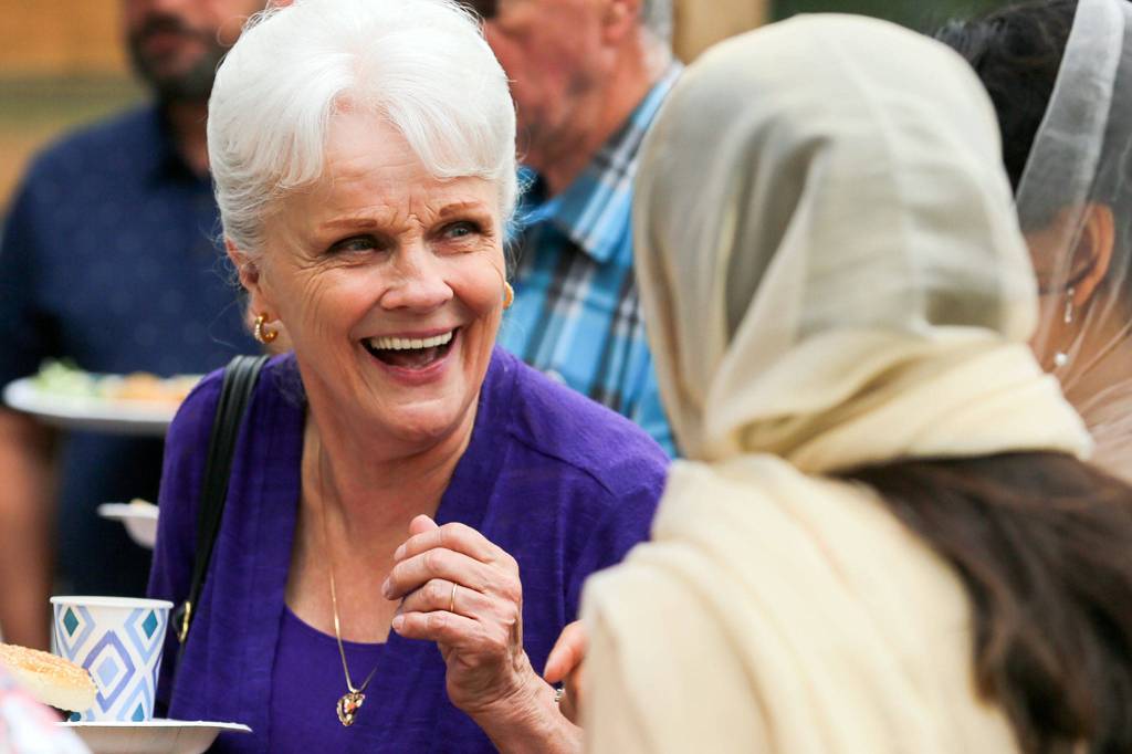 Liz Gimmestad shares a laugh Sunday morning at a block party hosted by the Husayniah Islamic Society of Seattle in Snohomish. (Kevin Clark / The Herald)