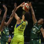 Dallas Isabelle Harrison (center) has her shot blocked by Seattles Jewell Loyd (right) with Seattles Crystal Langhorne (left) defending during a game on Aug. 8, 2019, at Angel of the Winds Arena in Everett. (Kevin Clark / The Herald)