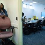 Kim McNeil-Capers, head of outreach programs at Queens Central Library, wait outside a room during setup of a videoconference between an incarcerated individual and a family member in Queens borough of New York. (AP Photo/Bebeto Matthews)