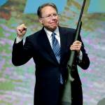 In this 2013 photo, Wayne LaPierre, executive vice president of the National Rifle Association, holds a custom 300 Remington ultra mag during a gun auction after speaking during the Western Hunting & Conservation Expo Banquet at the Salt Palace Convention Center in Salt Lake City. (AP Photo/Rick Bowmer, File)