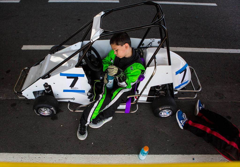 Holden Gorski, 11, rests in his car before the start of his race at the Washington Quarter Midgets race track on Aug. 4 in Monroe. (Olivia Vanni / The Herald)
