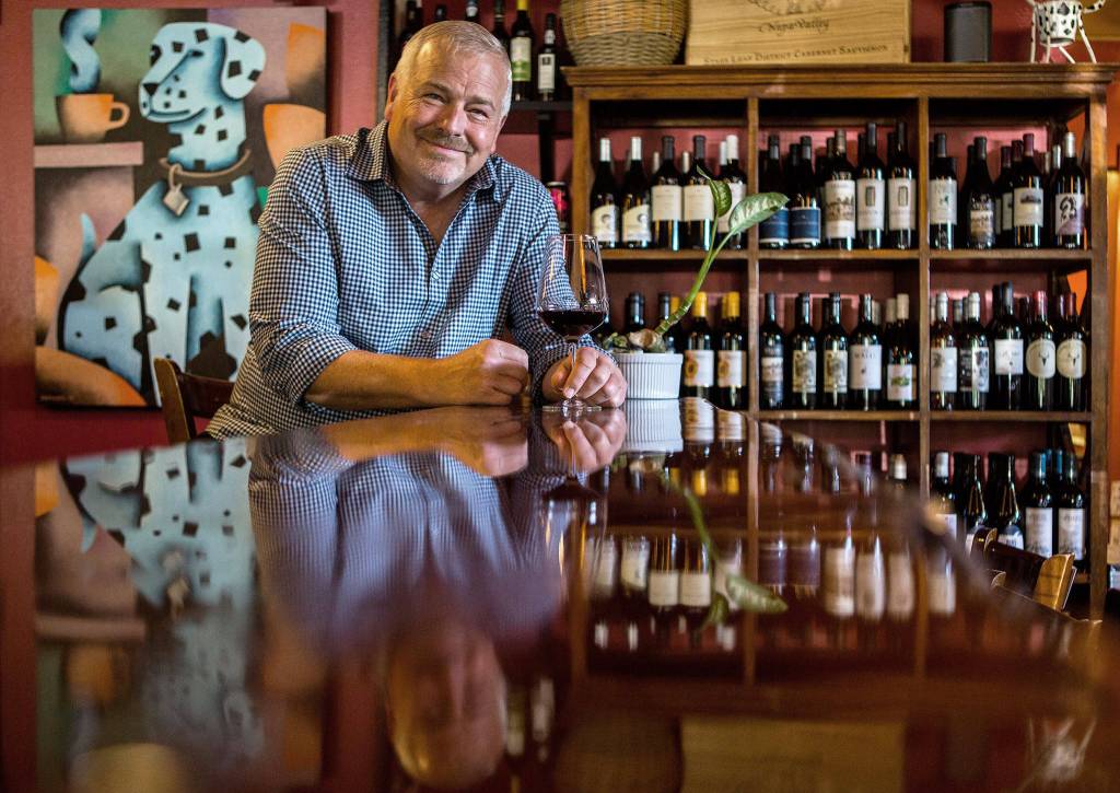 Jeff Wicklund, wine consultant and bar partner, enjoys a glass of wine at Cafe Zippys new wine bar, C.Vines, on June 24 in Everett. (Olivia Vanni / The Herald)