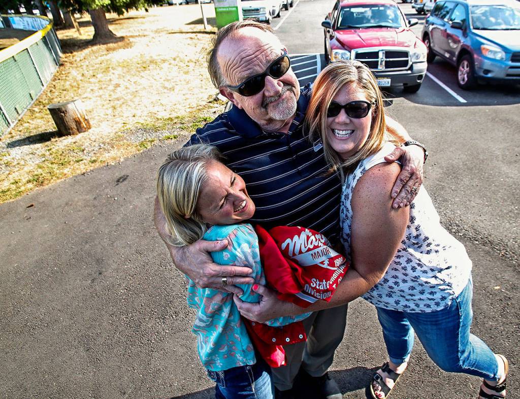 After the softball stories come hugs for these grown kids, who may always have something special between them. With manager and head coach Frank Grambo, Heidi Hale (left) and Jodie Bilow, mostly 12-year-olds, were part of a team at the 1989 Little League Softball World Series. (Dan Bates / The Herald)