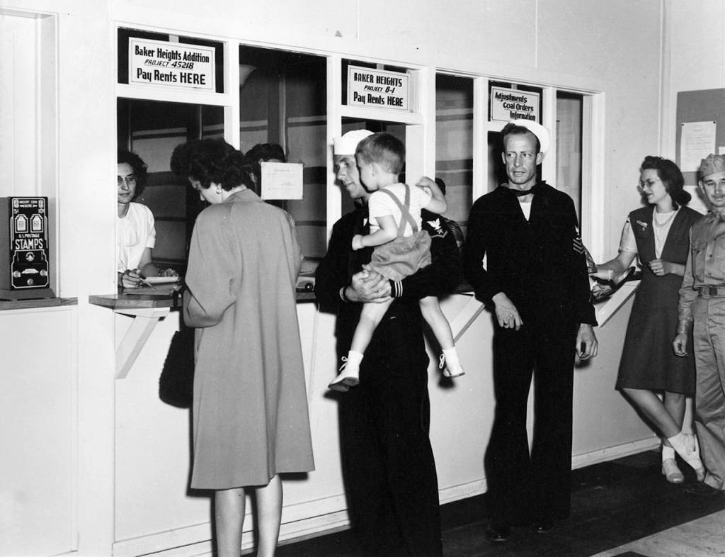 In an undated photo, Baker Heights residents pay rent. (Everett Public Library)