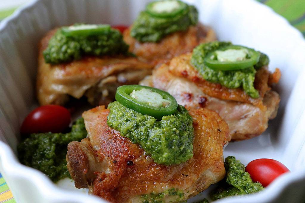 Gjustas green harissa  which is almost like a pesto  gives a nice heat to chicken thighs. (Hillary Levin/St. Louis Post-Dispatch)