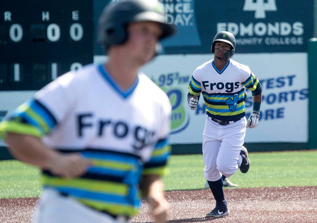 AquaSoxs Robert Perez follows Trent Tingelstad to home plate after hitting a three run homer as the The Everett AquaSox took on the Hillsboro Hops at Funko Field on Tuesday, Aug. 13, 2019 in Everett, Wash. (Andy Bronson / The Herald)