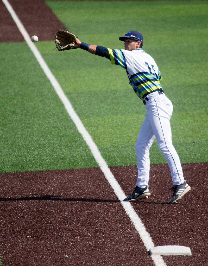 The AquaSoxs Patrick Frick reaches for the ball as it goes foul down the third base line as the Everett AquaSox took on the Hillsboro Hops at Funko Field on Tuesday, Aug. 13, 2019 in Everett, Wash. (Andy Bronson / The Herald)