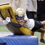 Washington cornerback Kyler Gordon hits a tackling dummy during a practice Aug. 5 in Seattle. (AP Photo/Elaine Thompson)