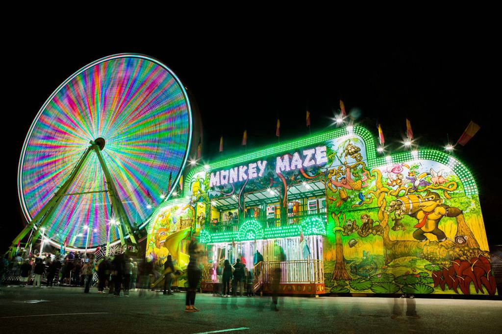 The carnival at the Evergreen State Fair glows at night in 2018. (Olivia Vanni / The Herald)