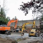 Heavy equipment is parked in former residential lots along I-5 in preparation for the light extension to Lynnwood slated to be completed in 2024. (Kevin Clark / The Herald)