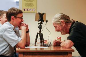 In a quiet room at the Everett Public Library Monday, Vietnam War veteran Bradley Andrews, 69, begins telling his story to Civil Air Patrol members Zachary Colburn, 14,(foreground), and Kenneth Butcher, 15, who record his image and voice on an iPod. He begins with the lighter stuff, but it doesnt take long to change. In Andrews laughter are hints of darker things. (Dan Bates / The Herald)