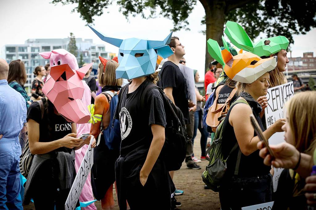 Left-aligning protesters gather near Battleship Oregon Memorial Marine Park on Saturday in downtown Portland. Hundreds of far-right protesters and anti-fascist counter-demonstrators swarmed the downtown area, as police set up concrete barriers and closed streets and bridges in an effort to contain and separate the rival groups. (AP Photo/Moriah Ratner)