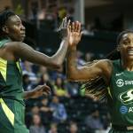 Natasha Howard of the Seattle Storm (left) shares a high-five with a teammate during the Storms WNBA game against Dallas on Aug. 8 at Angel of the Winds Arena in Everett. (Kevin Clark / The Herald)