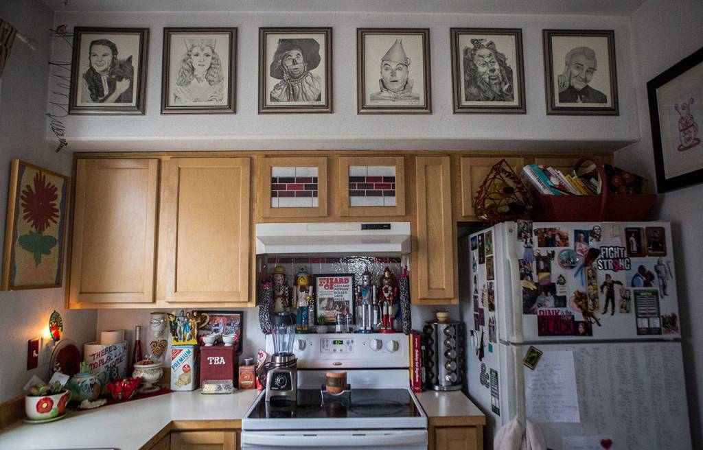 Wizard of Oz character sketches picked up by a family member hang on the wall over her kitchen which is also filled with Wizard of Oz items on Friday, Aug. 16, 2019 in Granite Falls, Wash. (Olivia Vanni / The Herald)