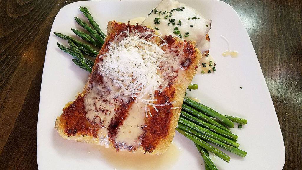 The Alaska cod parmesan has a panko and parmesan crust and came with au gratin potatoes and asparagus. (Sharon Salyer /The Herald)