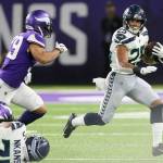Seattles Travis Homer (25) runs away from Minnesotas Marcus Epps (left) during Sundays preseason game in Minneapolis. (AP Photo/Jim Mone)