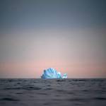 In this Aug. 15 photo, a large Iceberg floats away as the sun sets near Kulusuk, Greenland. Scientists are hard at work there, trying to understand the alarmingly rapid melting of the ice. (AP Photo/Felipe Dana)