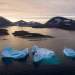 In this Aug. 16 photo, large Icebergs float away as the sun rises near Kulusuk, Greenland. (AP Photo/Felipe Dana)