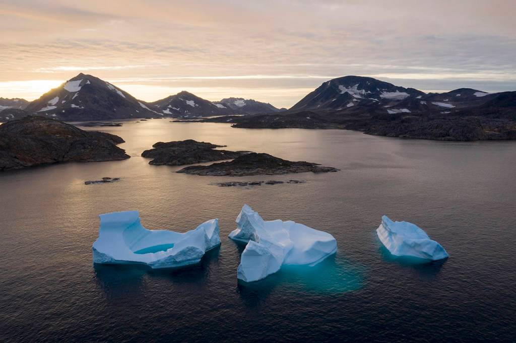 In this Aug. 16 photo, large Icebergs float away as the sun rises near Kulusuk, Greenland. (AP Photo/Felipe Dana)