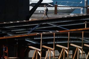 A man looks up at the Grand Avenue Park Bridge as he walks along the marina on Monday, Aug. 26, 2019 in Everett, Wash. (Andy Bronson / The Herald)