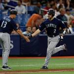 Seattles Tom Murphy (2) shakes hands with third-base coach Chris Prieto (13) after Murphy hit a two-run home run off Tampa Bay Rays relief pitcher Jalen Beeks in the sixth inning of Tuesdays game in St. Petersburg, Florida. (AP Photo/Chris OMeara)