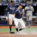 Tampa Bays Willy Adames (front) reacts to scoring the game-winning run on a wild pitch by Seattles Matt Magill during the ninth inning Wednesday in St. Petersburg, Florida, as Tommy Pham looks on. (AP Photo/Chris OMeara)