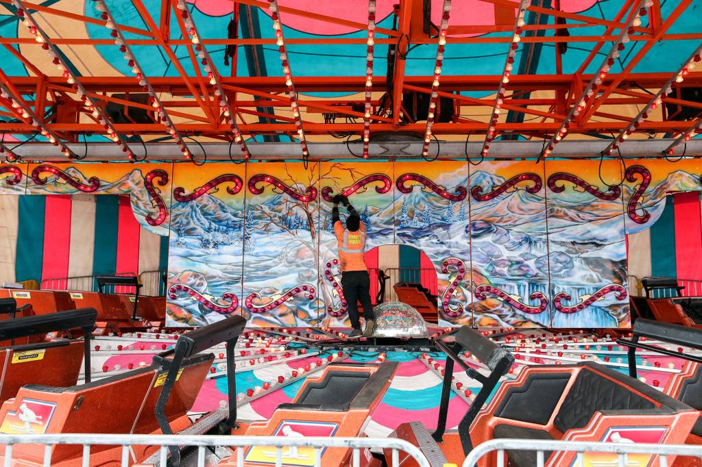 Finishing touches are placed on a ride Wednesday afternoon at the Evergreen State Fairgrounds in Monroe on August 21, 2019. (Kevin Clark / The Herald)