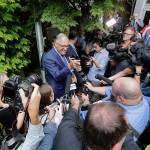 Gov. Jay Inslee is surrounded by reporters as he speaks about his plans to run for a third term as governor Thursday in Seattle. (AP Photo/Elaine Thompson)