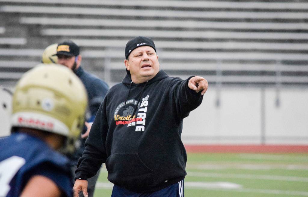 Everetts first-year head coach, Brien Elliott, participates in his teams seven-on-seven drills at Everett Memorial Stadium on Wednesday, Aug. 21. (Katie Webber / The Herald)