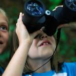 Doras backpack always has what she needs inside, including a pair of binoculars. Here, Bella Ivanova, then 9, left, and sister Gabi, then 7, look for birds through their binoculars on a hike through Meadowdale Beach Park in 2013. (Genna Martin/Herald file)