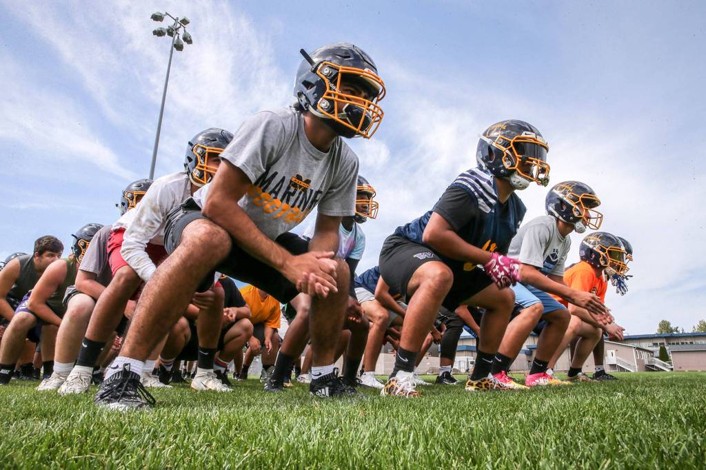 Mariner players rally before drills during practice on Aug. 22, 2019, at Mariner High School in Everett. (Kevin Clark / The Herald)