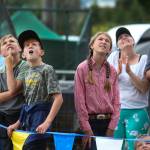 Kids watch as loggers climb 60 foot poles during the International Lumberjack Show on opening day of the Evergreen State Fair on Thursday, Aug. 22, 2019 in Monroe, Wash. The cabin is the first building to be placed on the Snohomish County Register of Historic Places. (Andy Bronson / The Herald)