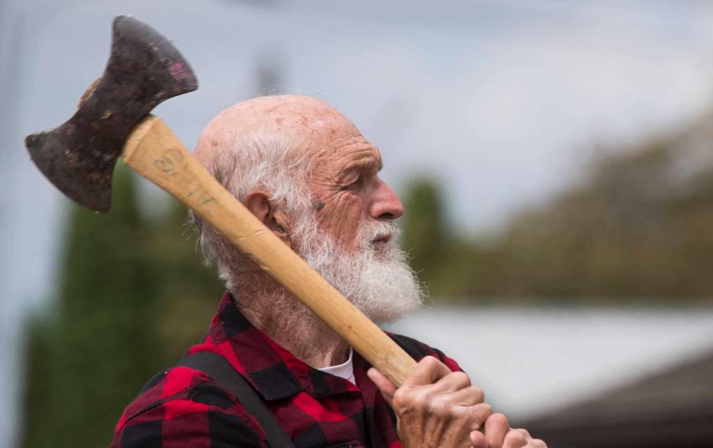 Alvie Marcellus takes look at his target before throwing an axe during the International Lumberjack Show on opening day of the Evergreen State Fair on Thursday, Aug. 22, 2019 in Monroe, Wash. The cabin is the first building to be placed on the Snohomish County Register of Historic Places. (Andy Bronson / The Herald)