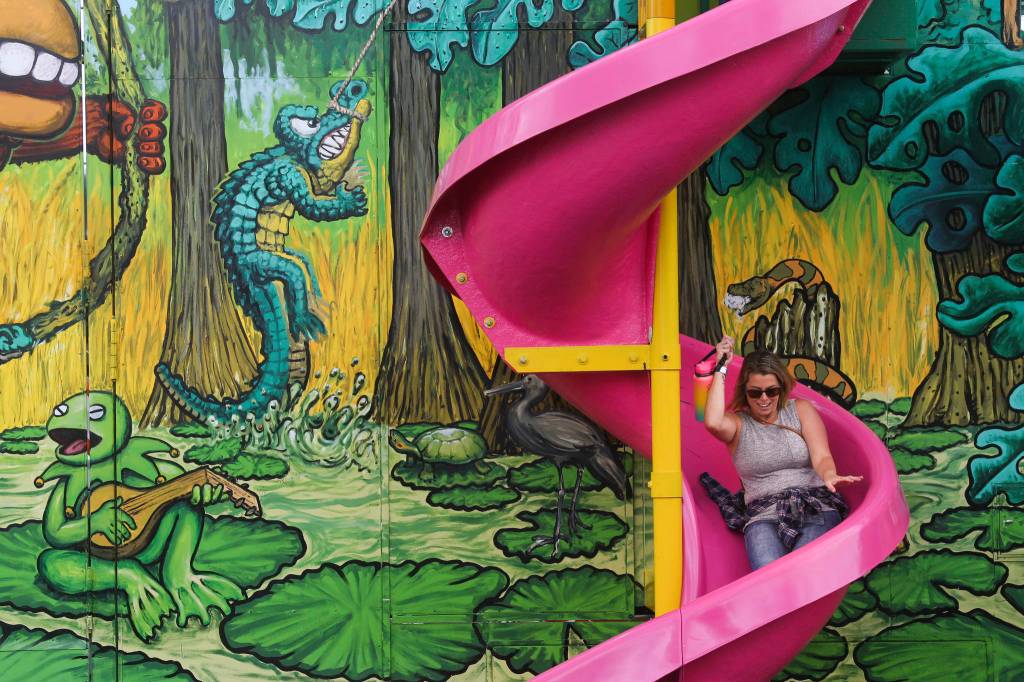 Even the adults can have fun as Tiara Wallner, of Lake Stevens, does sliding down the Monkey Maze slide on opening day of the Evergreen State Fair on Thursday, Aug. 22, 2019 in Monroe, Wash. (Andy Bronson / The Herald)