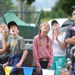 Kids watch as loggers climb 60 foot poles during the International Lumberjack Show on opening day of the Evergreen State Fair on Thursday, Aug. 22, 2019 in Monroe, Wash. The cabin is the first building to be placed on the Snohomish County Register of Historic Places. (Andy Bronson / The Herald)