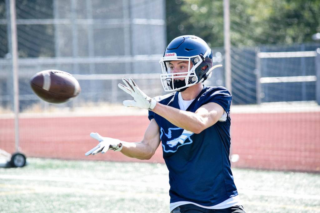 Senior Mason Vaughn catches the ball during wide receiver drills at Meadowdale High School on Thursday, Aug. 22. (Katie Webber / The Herald)
